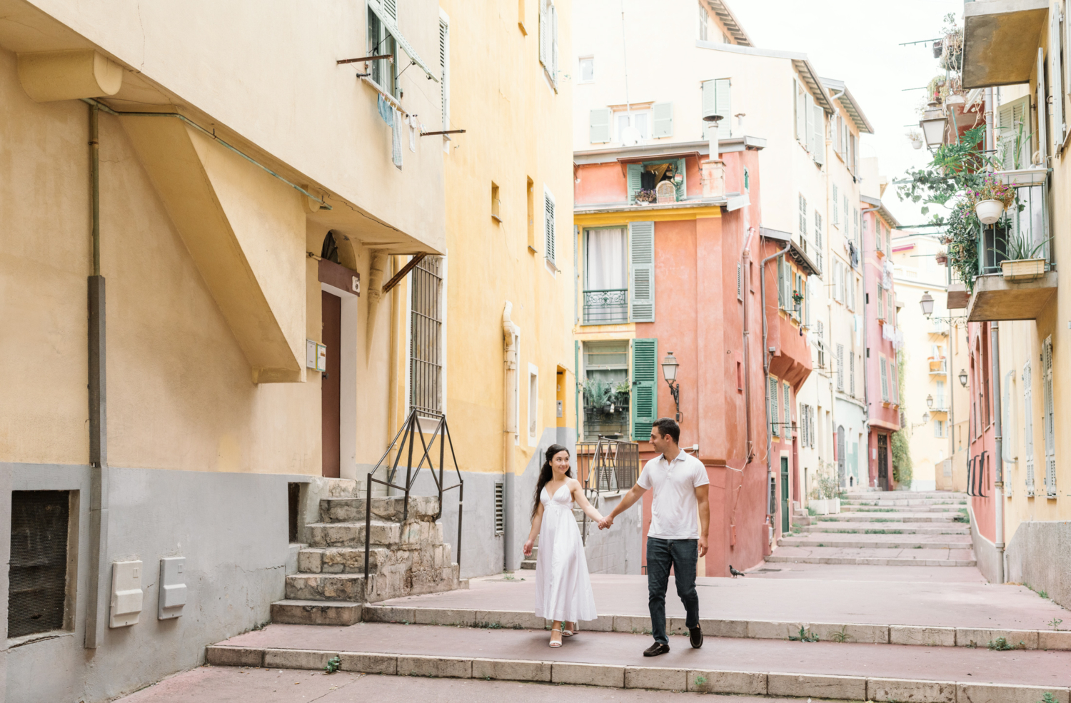 engaged couple walk together in old town nice france