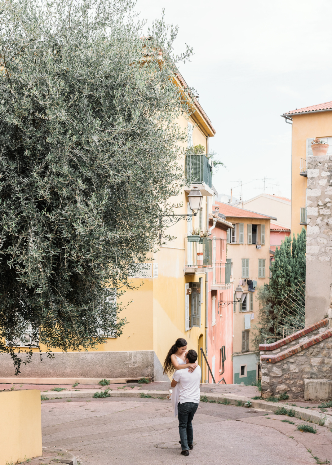 man and woman embrace in old town nice france