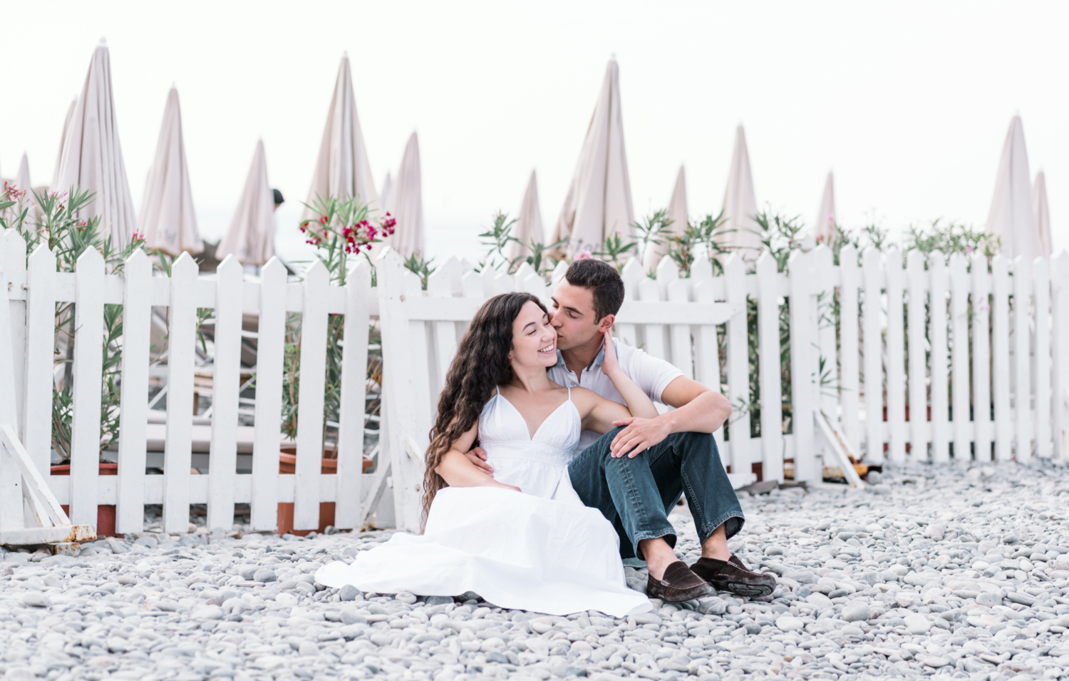 newly engaged couple kiss on beach in nice france