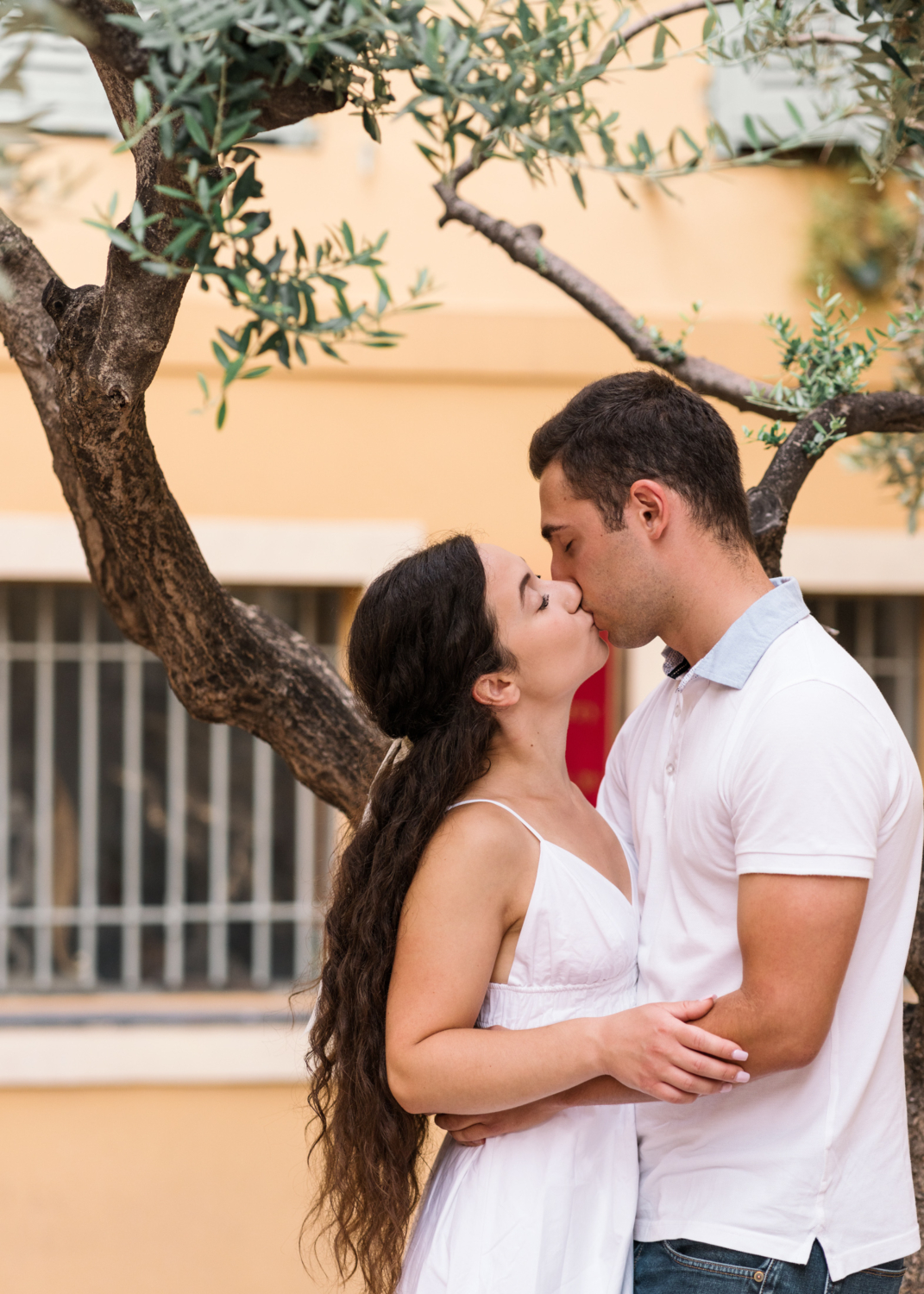 cute couple kiss in old town nice france under a tree