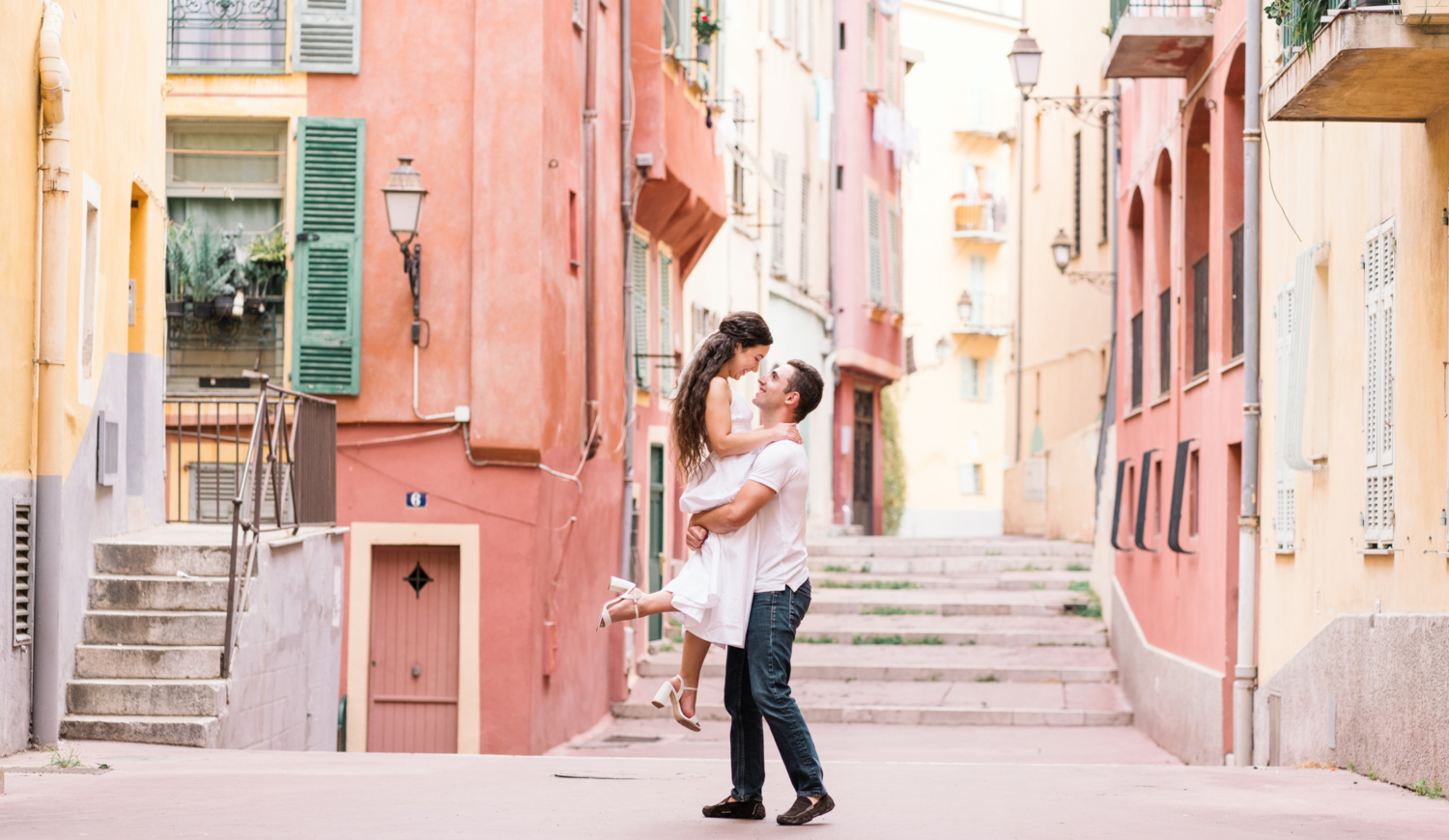 man lifts woman in air in old town nice