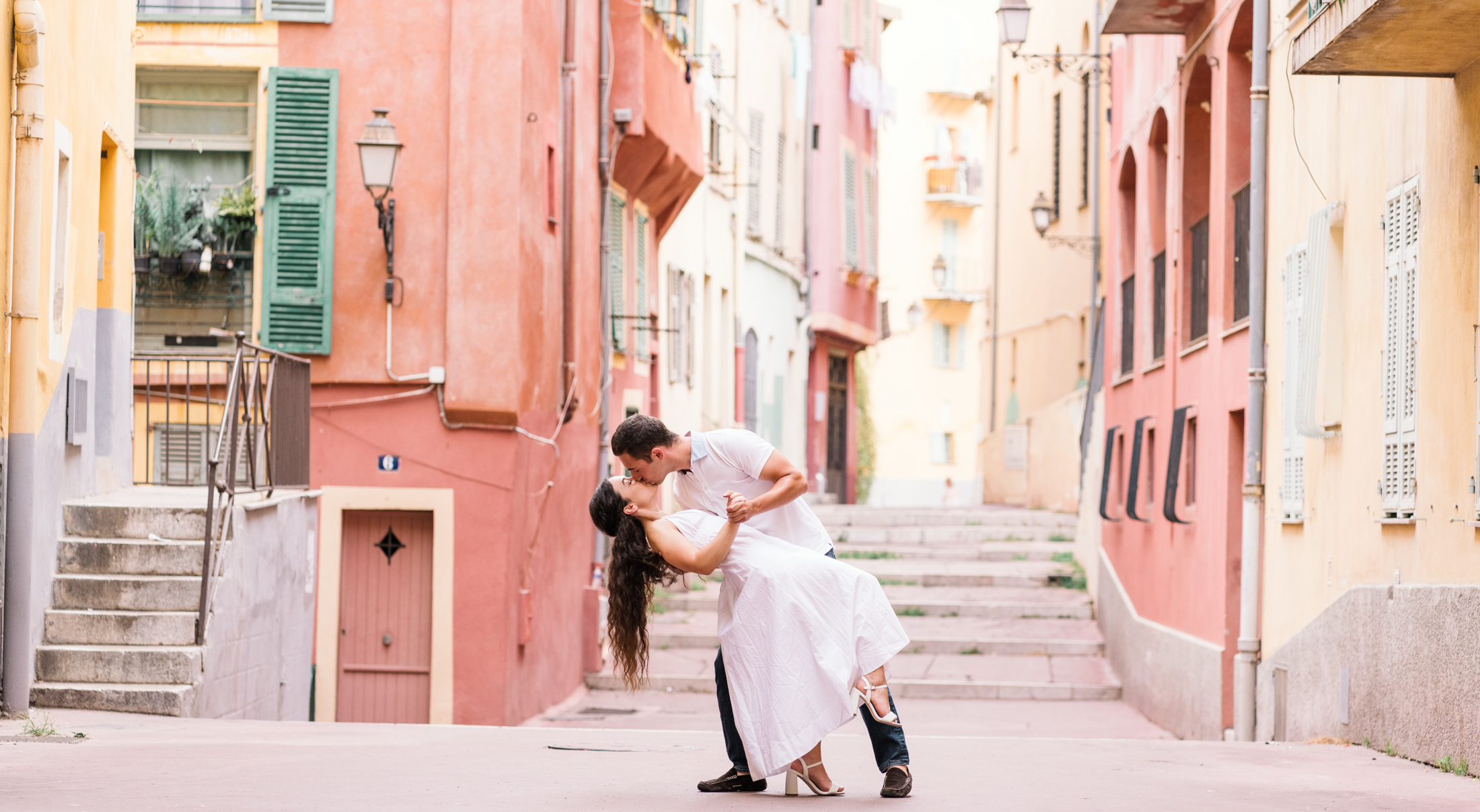 man dips woman backward and kisses her in old town nice