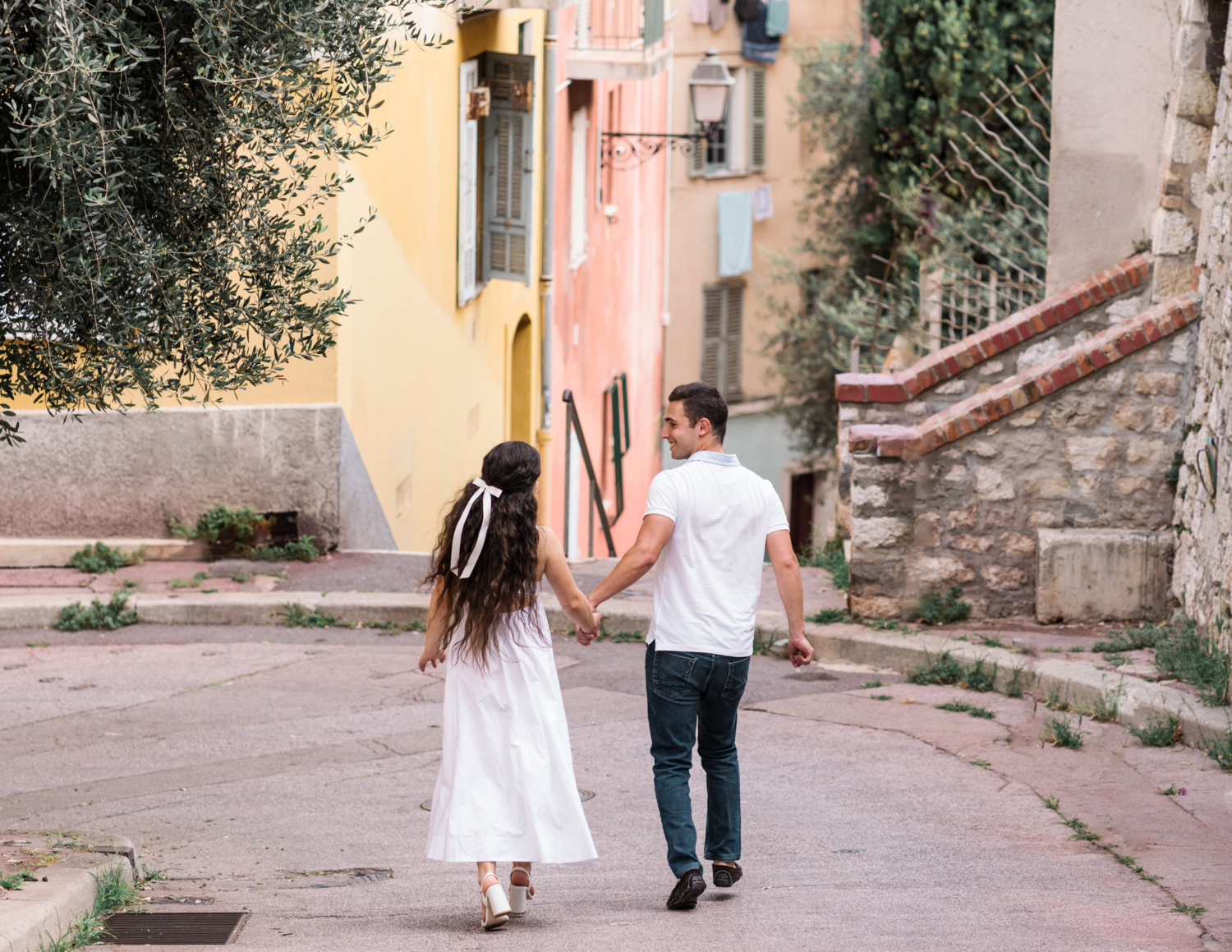 cute couple walk through old town in nice france