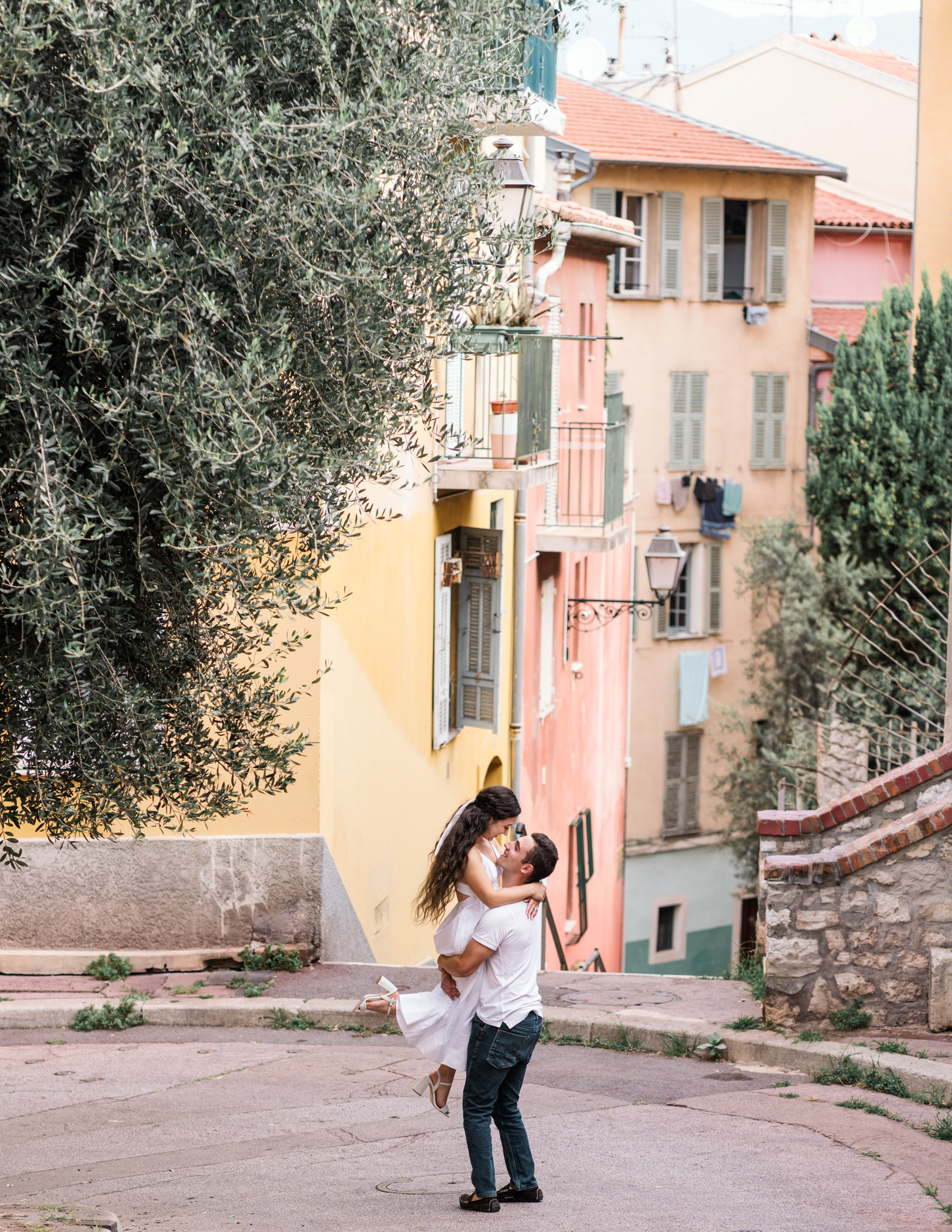 man lifts girlfriend in air in old town nice france