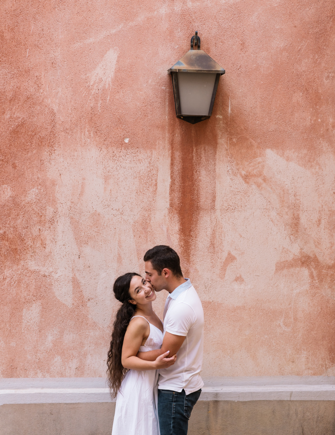 engaged couple embrace under lamp in nice france