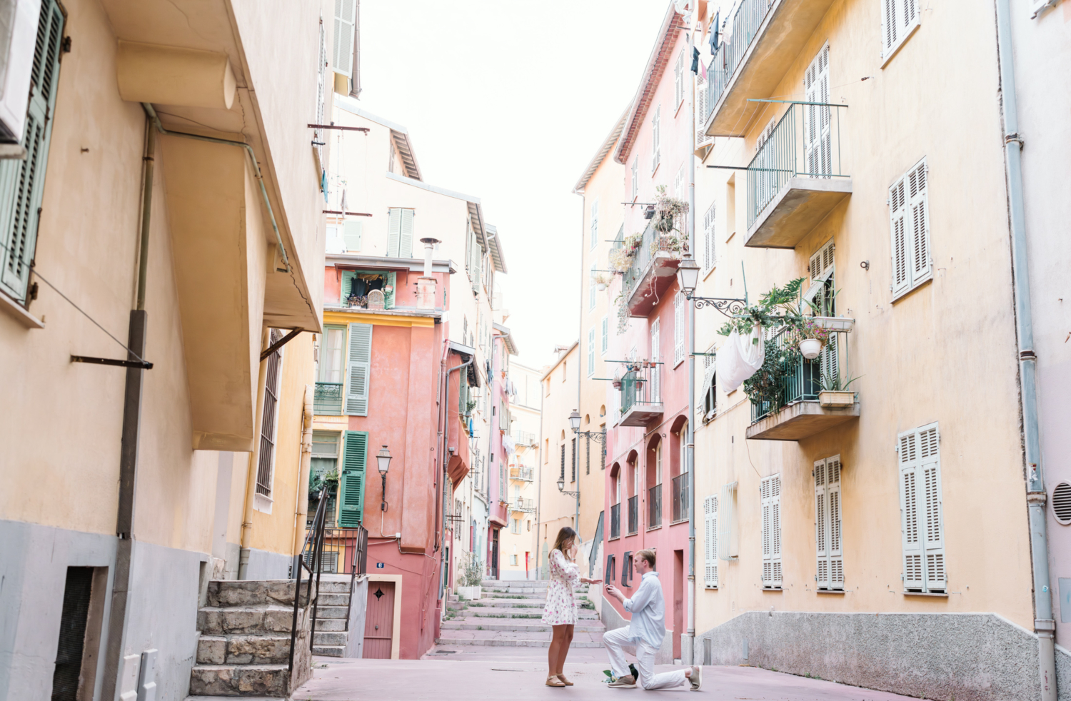 man puts ring on finger of woman after proposal in nice france