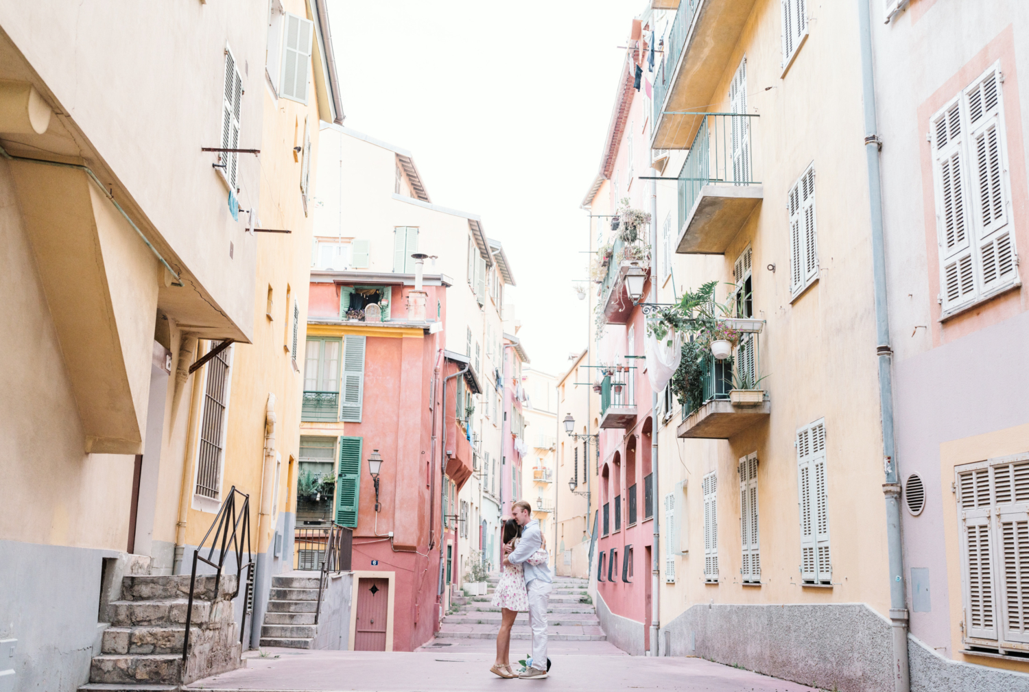 couple embrace after surprise proposal in nice france