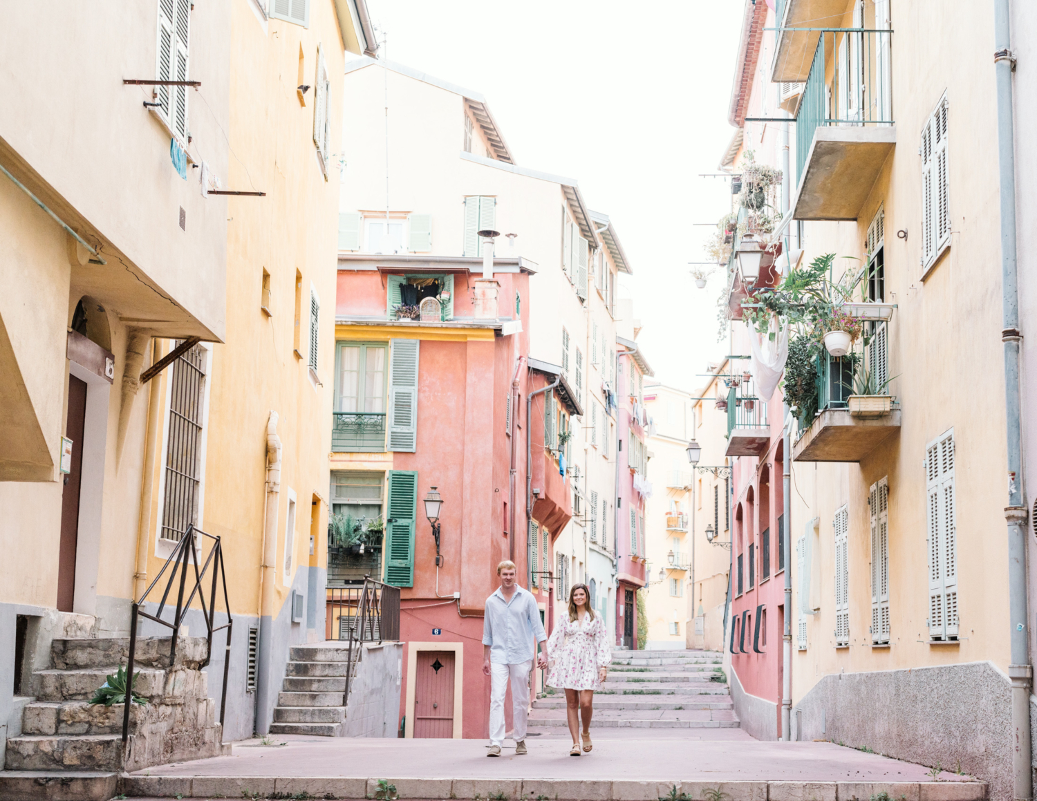 newly engaged couple walk through the colorful streets of nice france