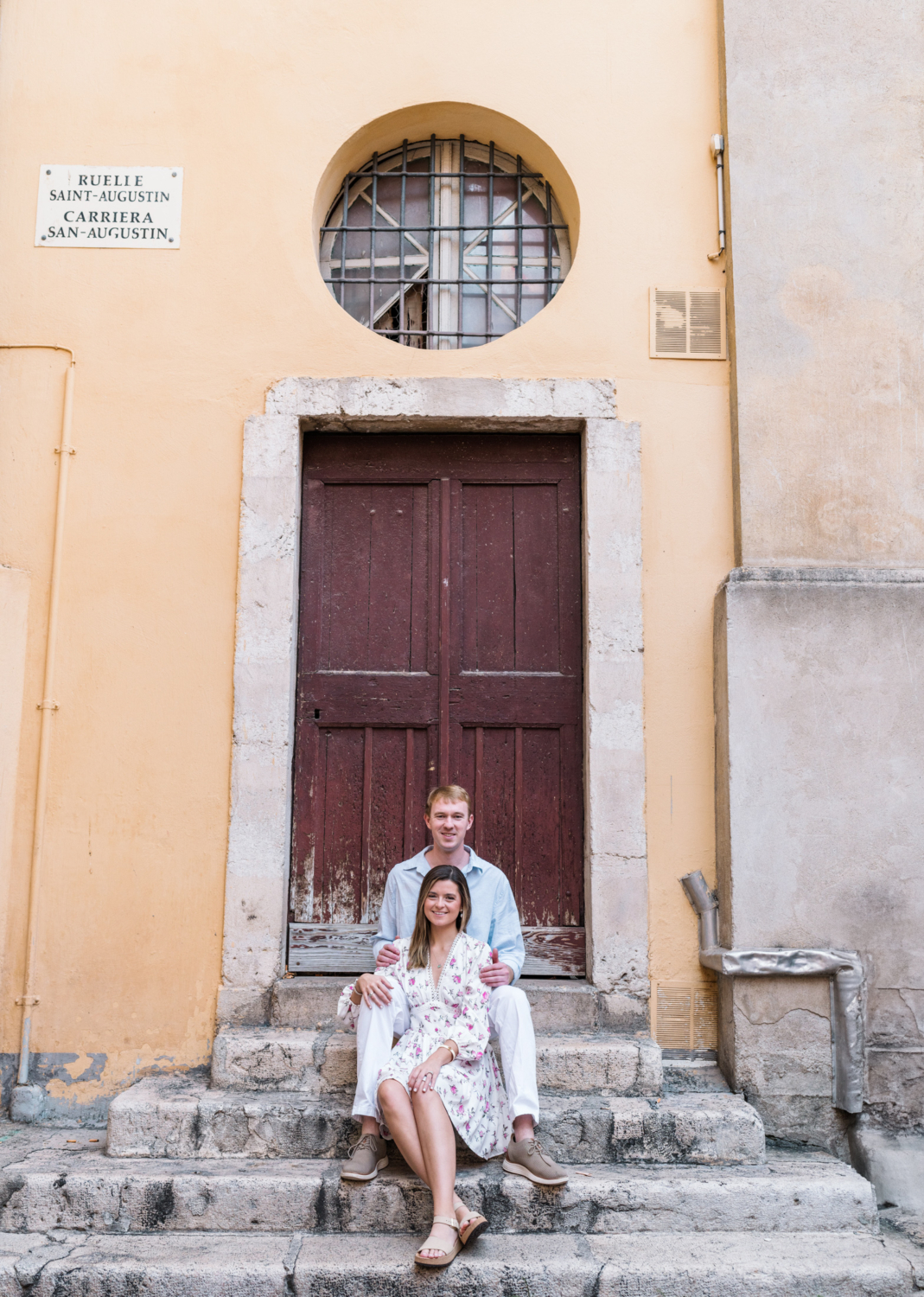 cute couple pose on staircase of church in nice france