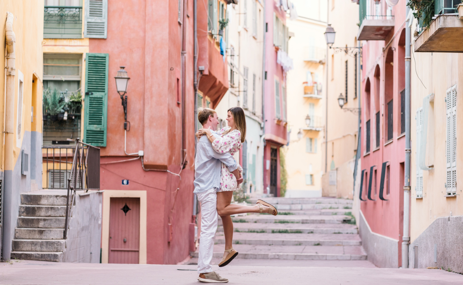 man lifts woman in air in old town nice france