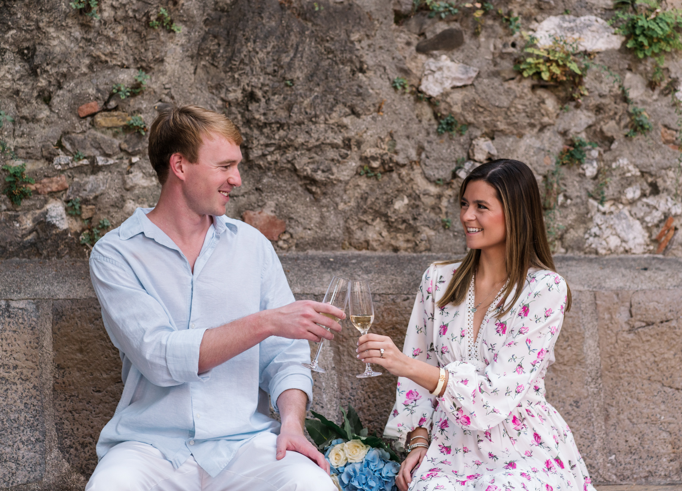 newly engaged couple toast each other in nice france