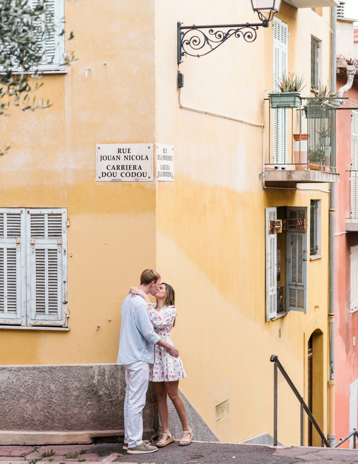 newly engage couple kiss on street corner in old town nice france