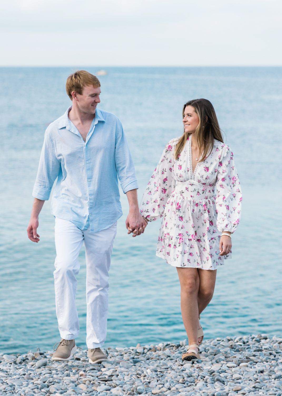 newly engaged couple walk on beach in nice france