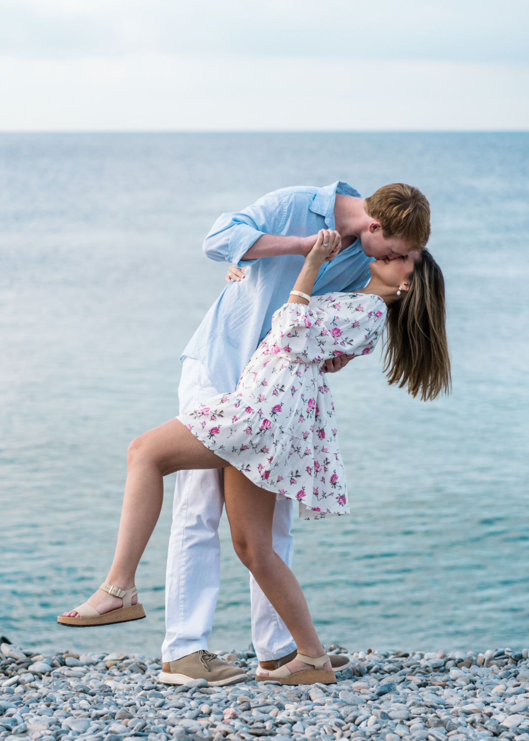 newly engaged couple kiss and dance on beach in nice france