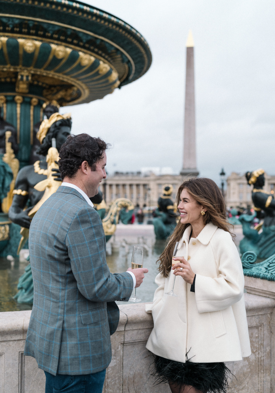 newly engaged couple enjoy champagne at place de la concorde paris