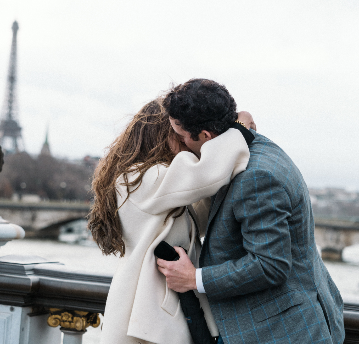 newly engaged couple hug after surprise proposal in paris