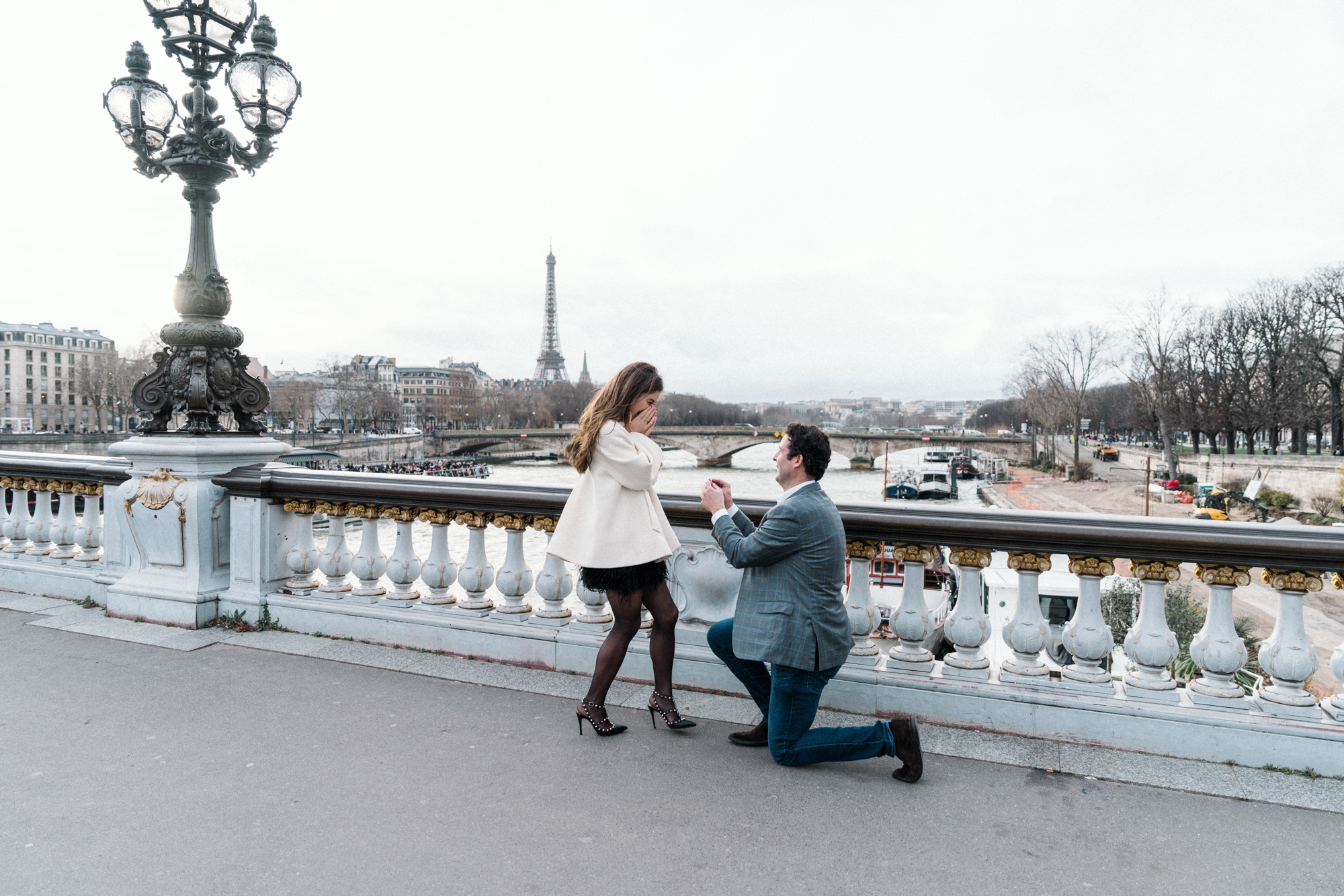 woman surprise as man presents diamond ring in paris