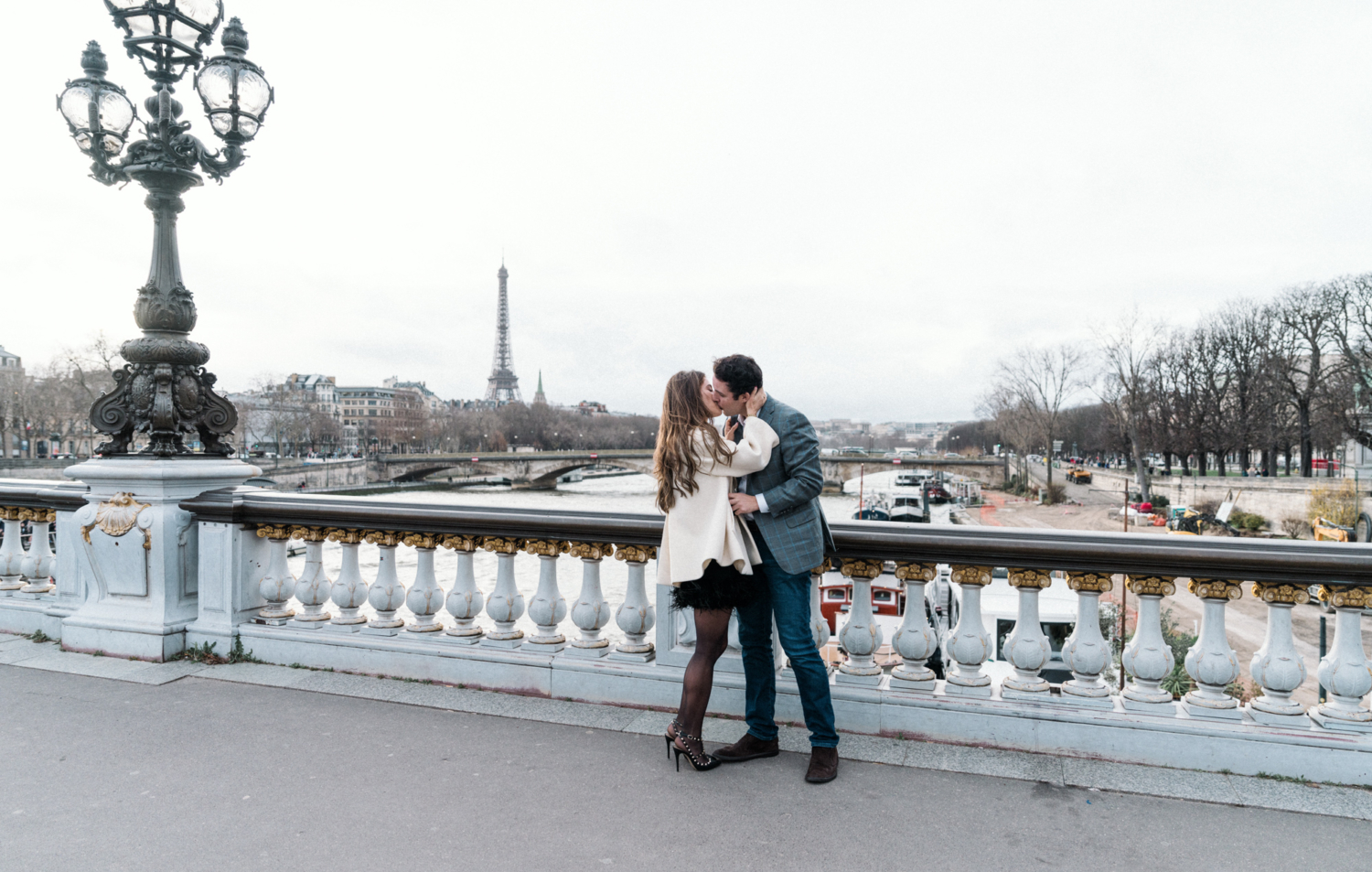 newly engaged couple kiss on pont alexandre bridge in paris