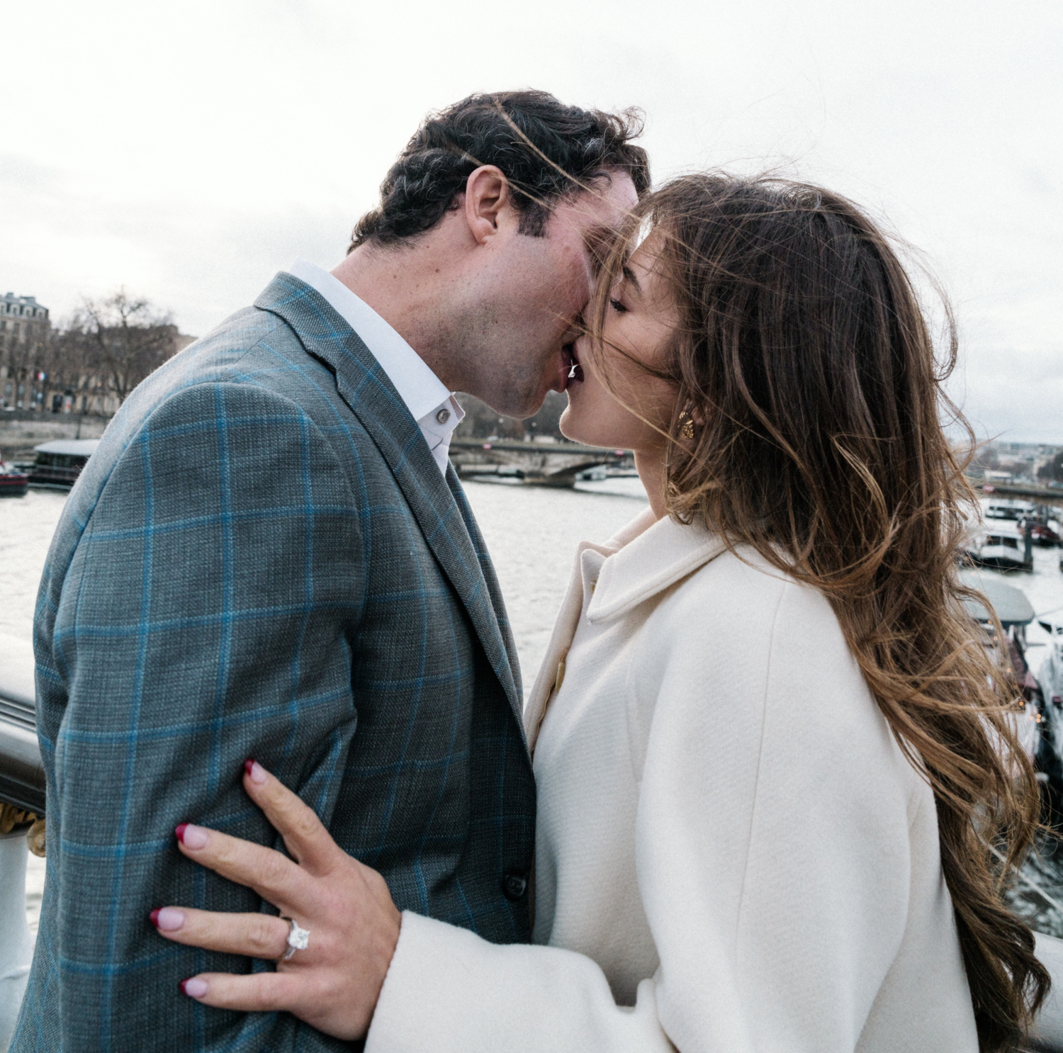 newly engaged couple passionately kiss