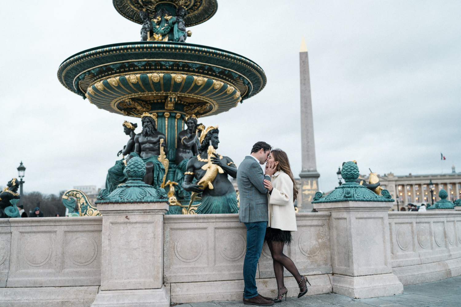 newly engaged couple kiss passionately at place de la concorde paris