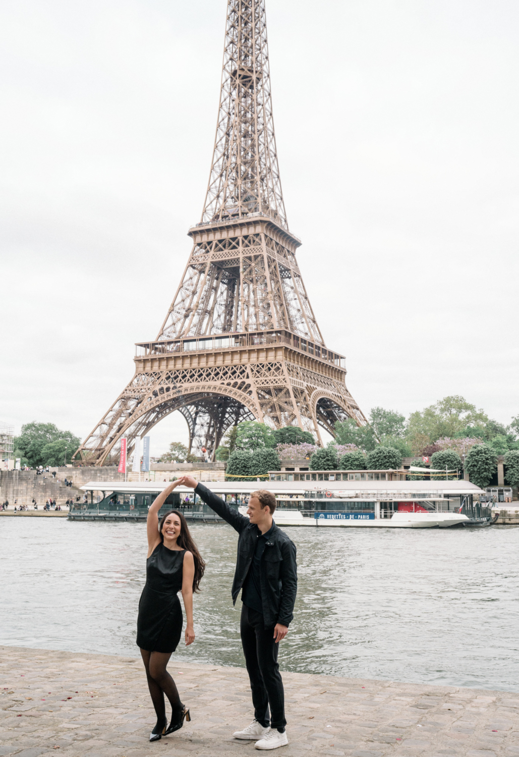 man twirls fiancee at eiffel tower paris