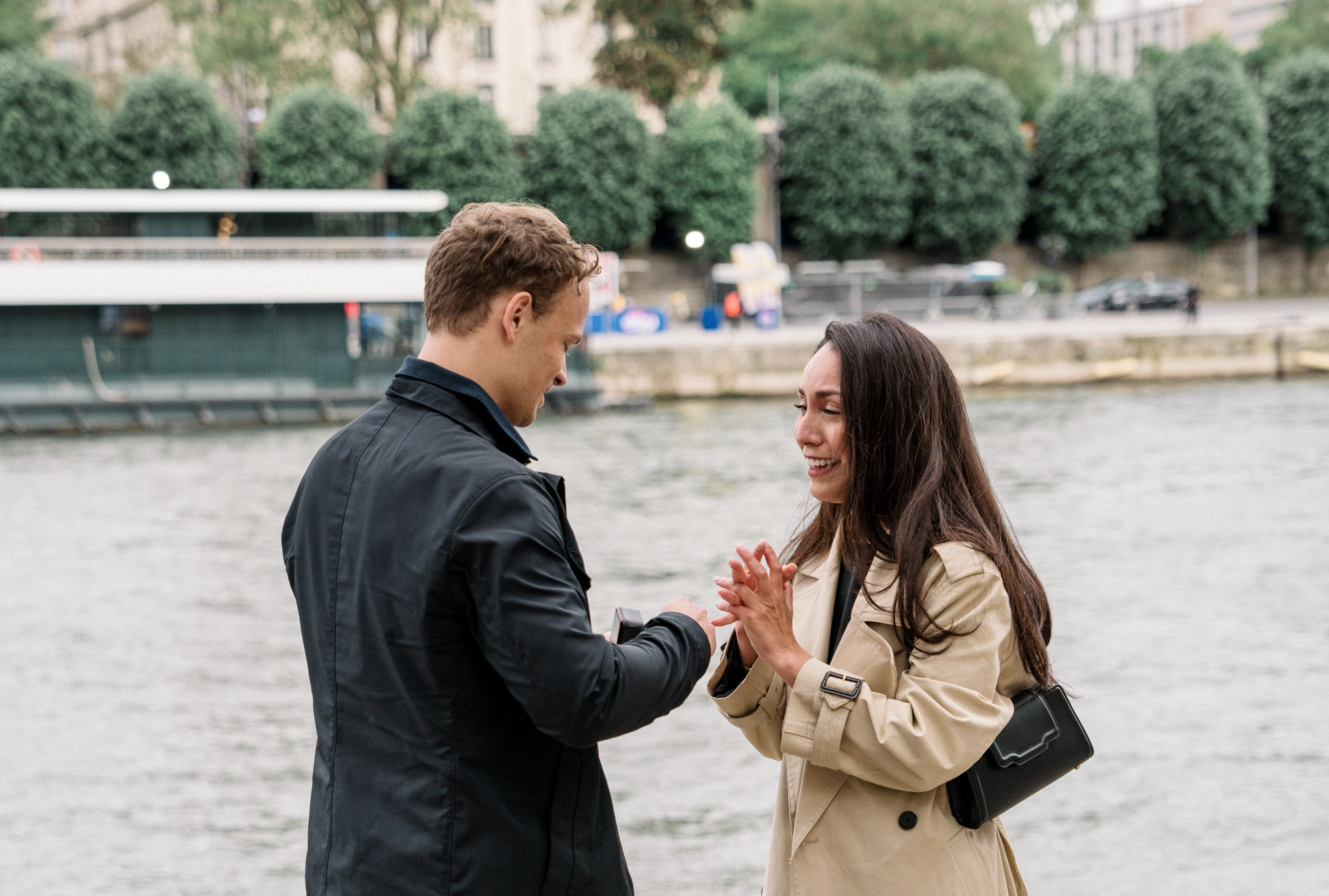man presents engagement ring to woman in paris