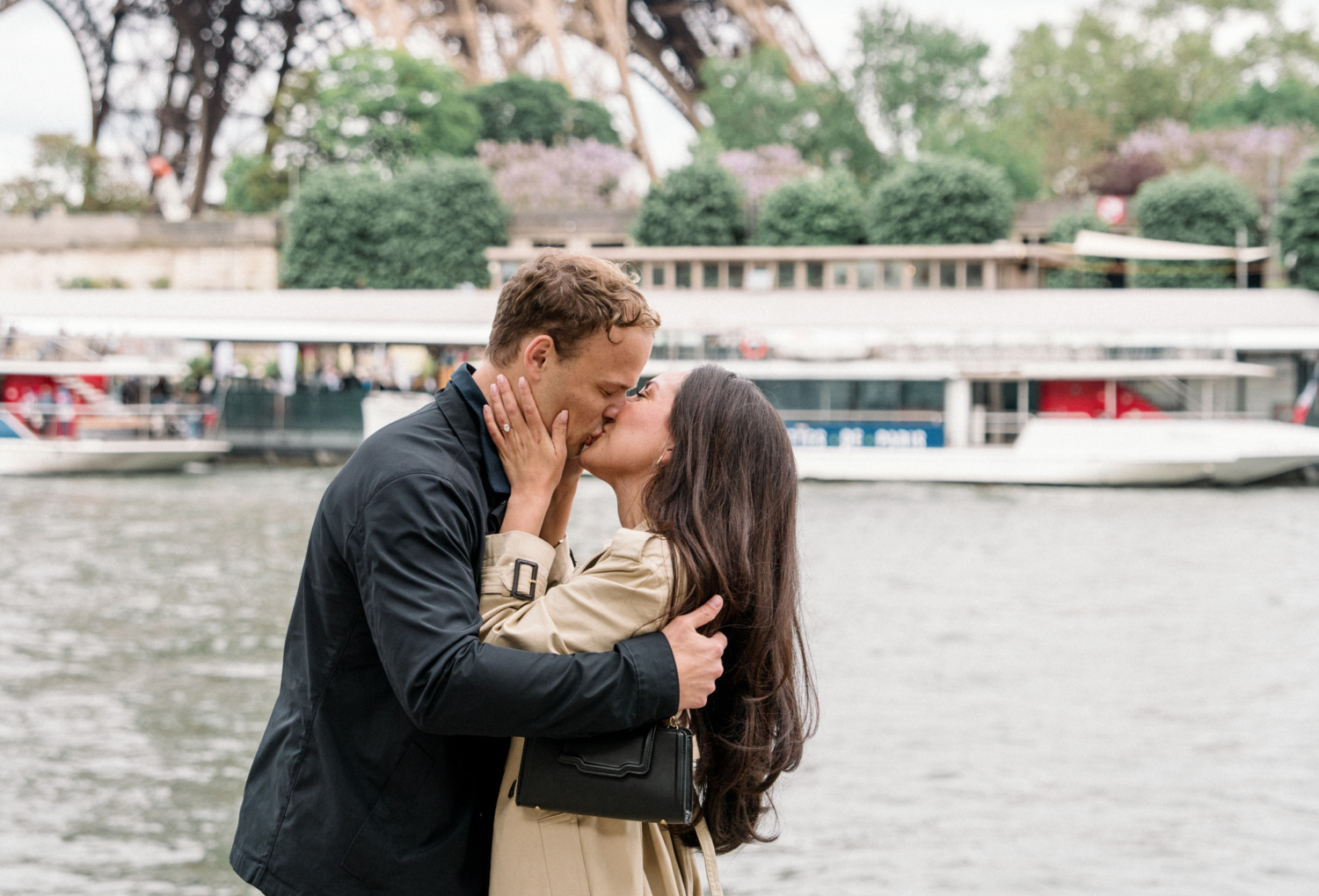 couple kiss after surprise proposal in paris