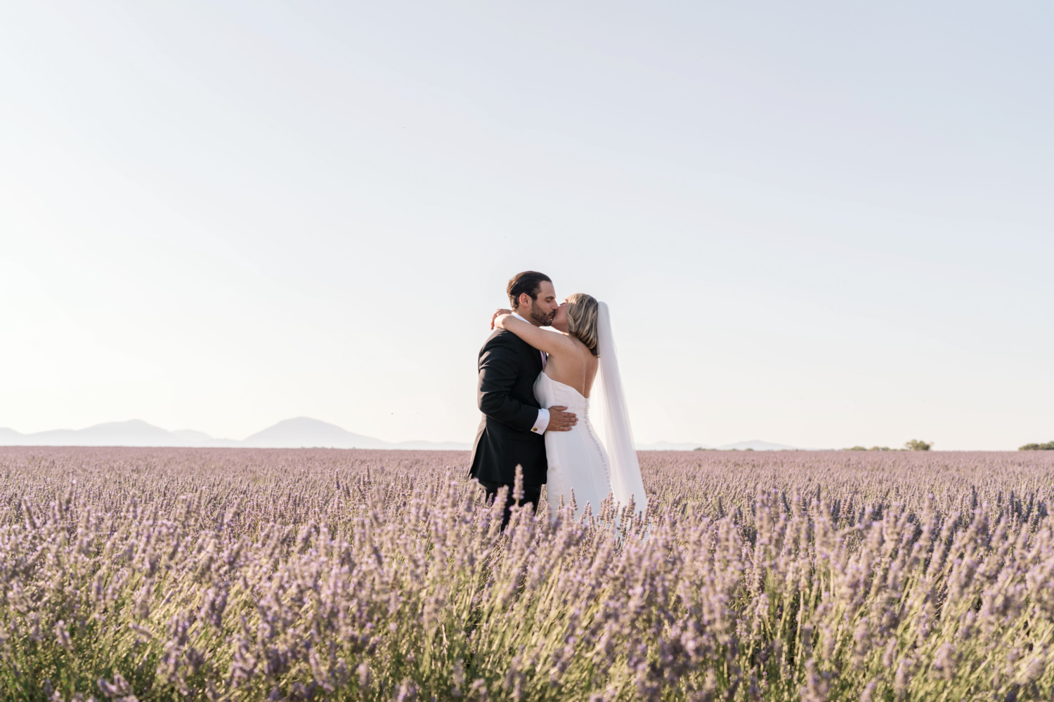 bride and groom embrace in lavender field in provence france