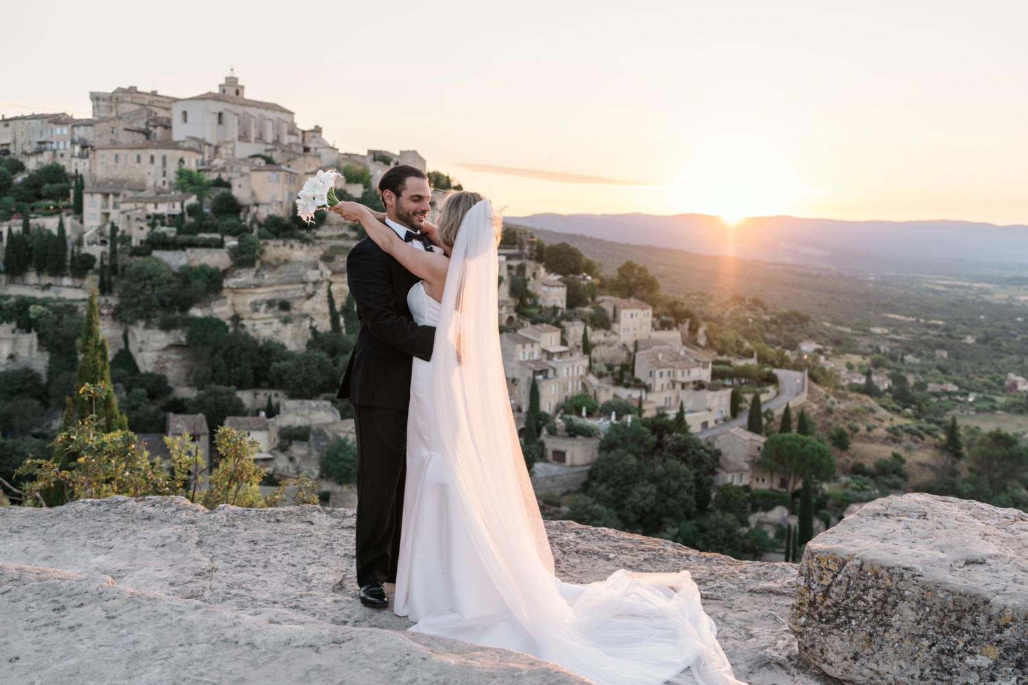 bride and groom embrace as the sun is coming up in gordes france