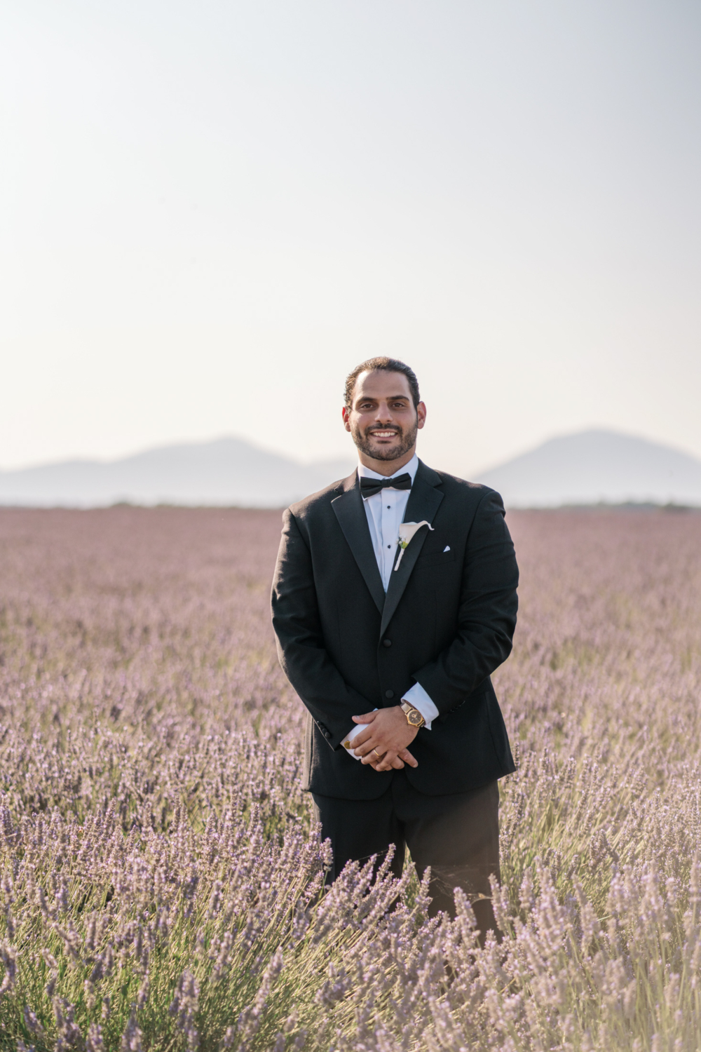 groom smiles in a lavender field