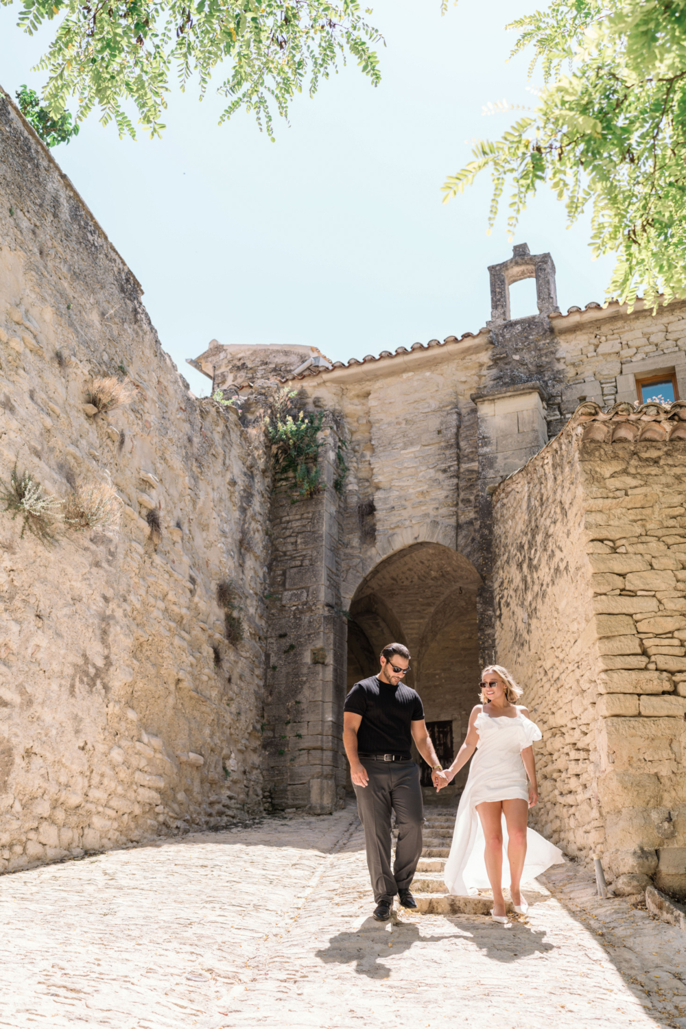 bride and groom walk through medieval old town in france