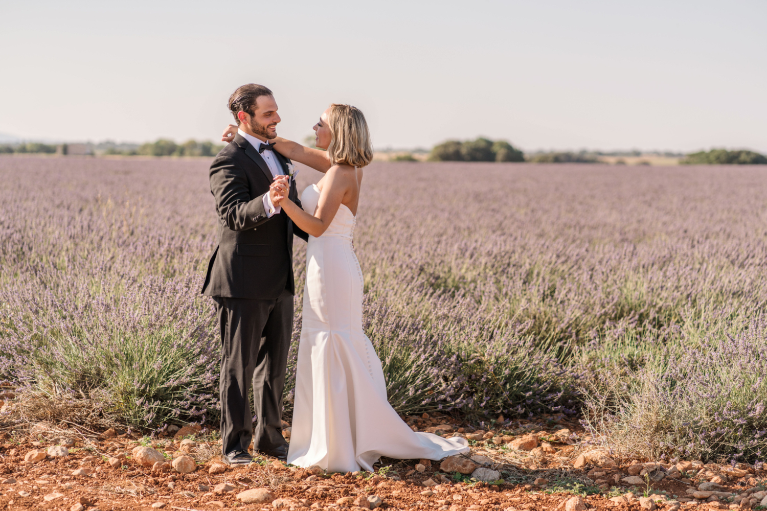 bride and groom dance after their elopement in provence france next to a lavender field