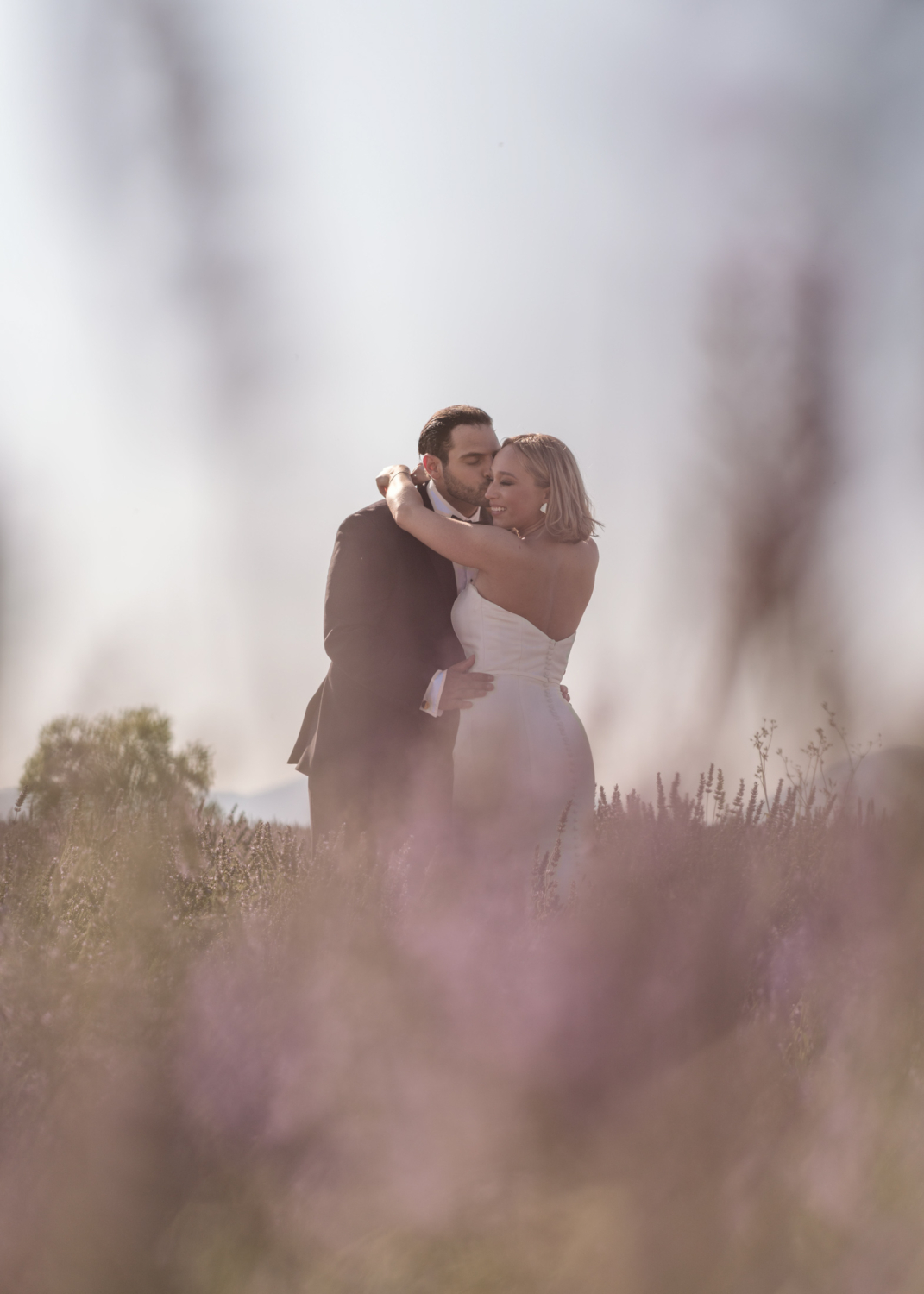 bride and groom embrace in lavender field in provence france