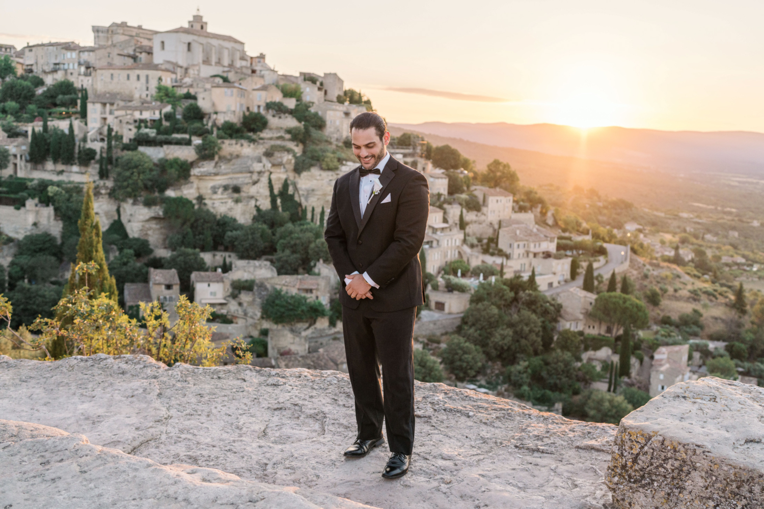 groom has a laugh at sunrise in gordes france