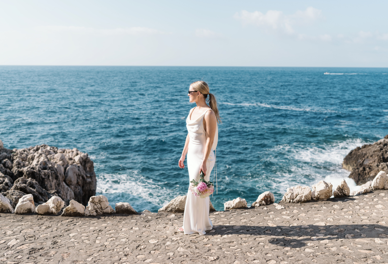 bride poses with view of sea on french riviera