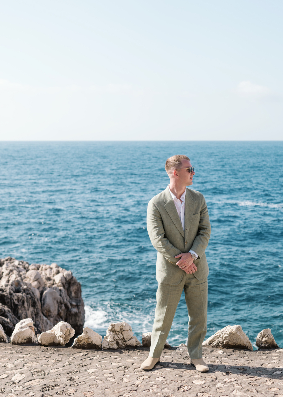 groom poses on wedding day french riviera