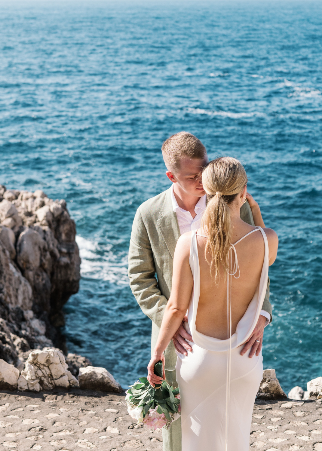 bride and groom embrace on french riviera