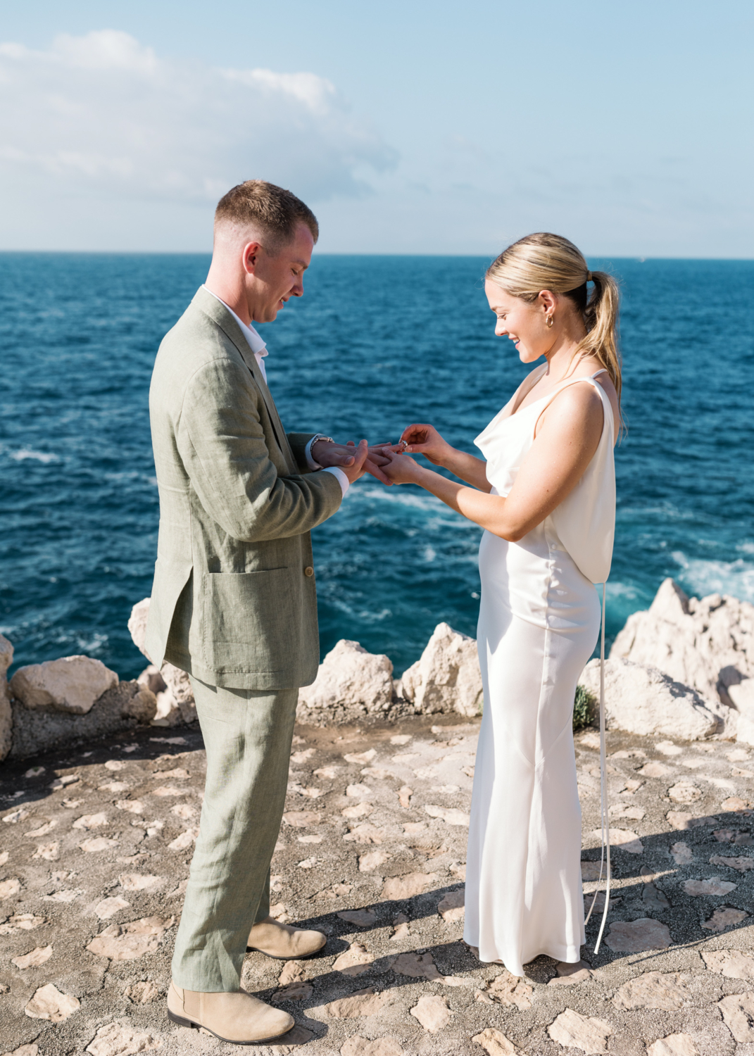 bride and groom exchange rings on the french riviera