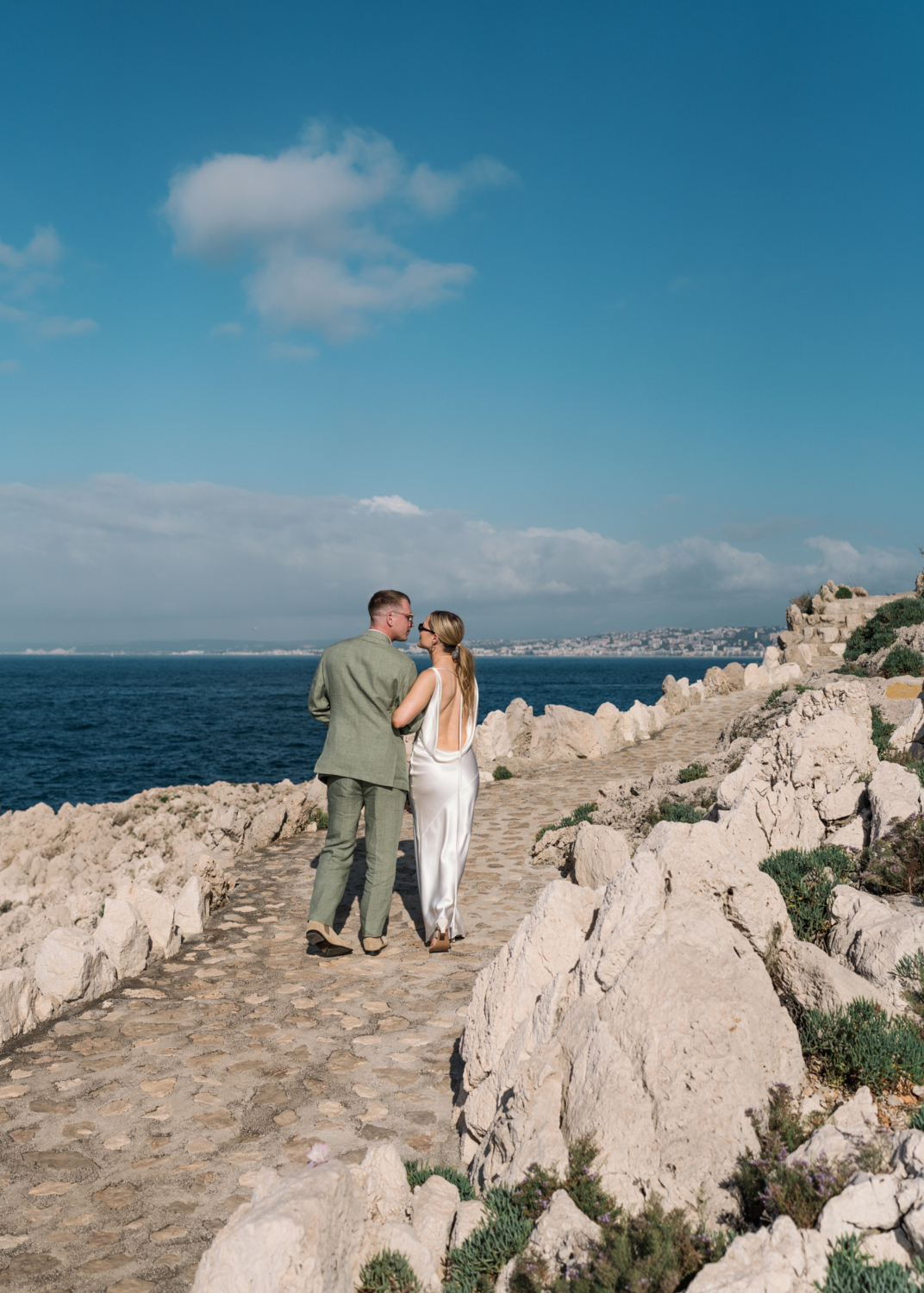 bride and groom walk arm in arm on the french riviera