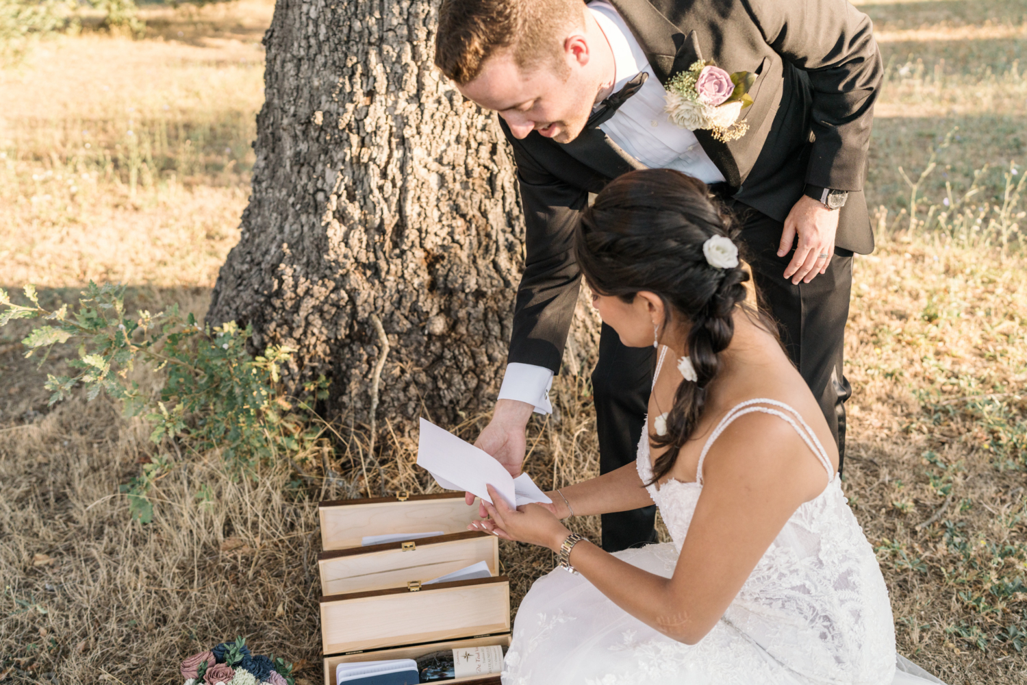 bride and groom place notes in boxes on their wedding day