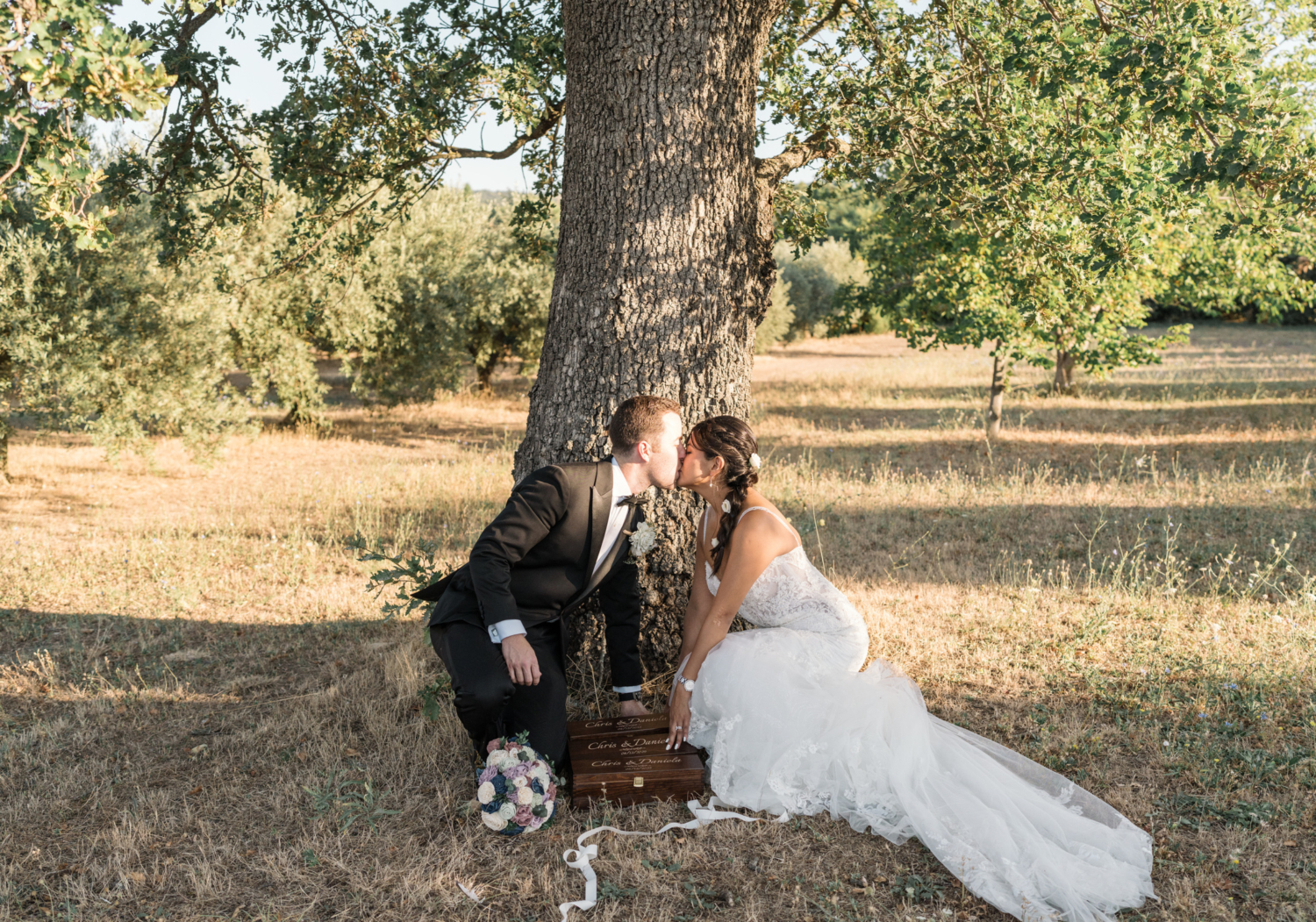 bride and groom kiss after their ceremony in olive grove in gordes france