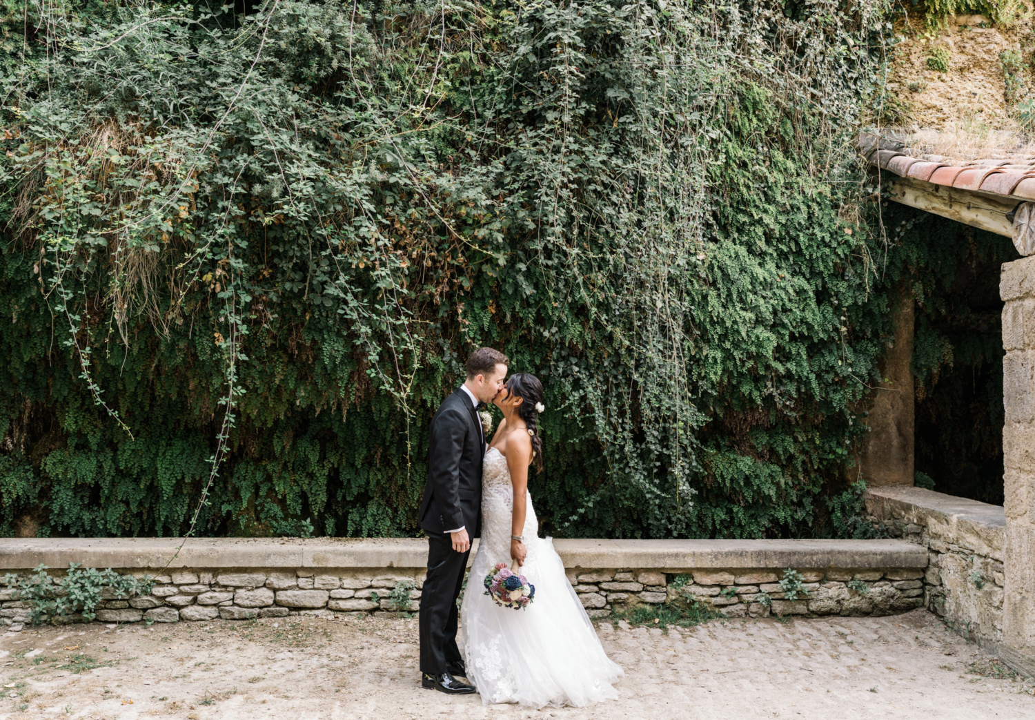 newlyweds kiss near lavoir in gordes france