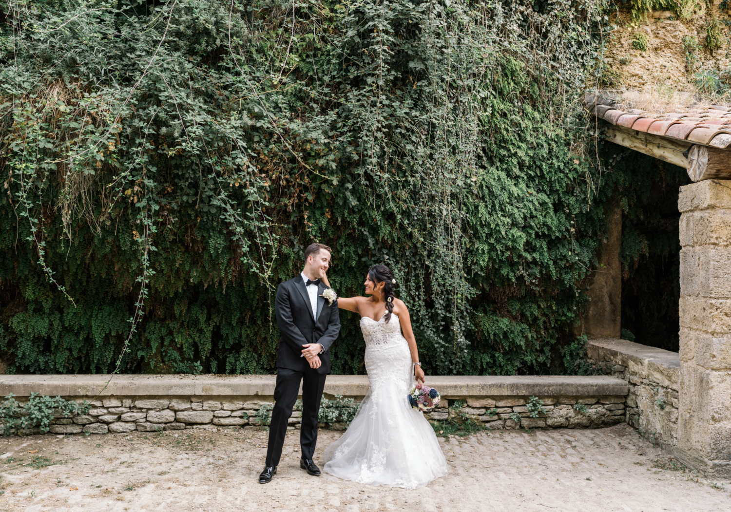 bride and groom laugh at the lavoir in gordes france