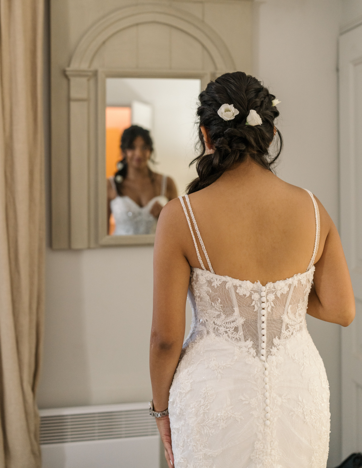 bride looks in mirror on her wedding day in gordes france