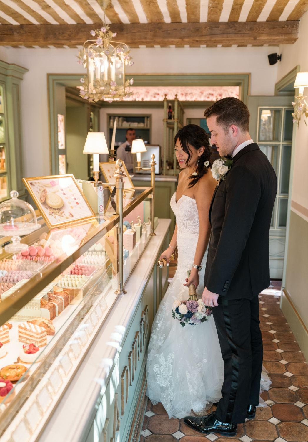 bride and groom in la duree macaroon shop