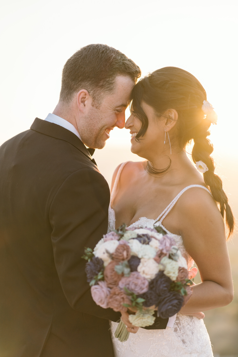 bride and groom laugh ast sunrise in gordes france