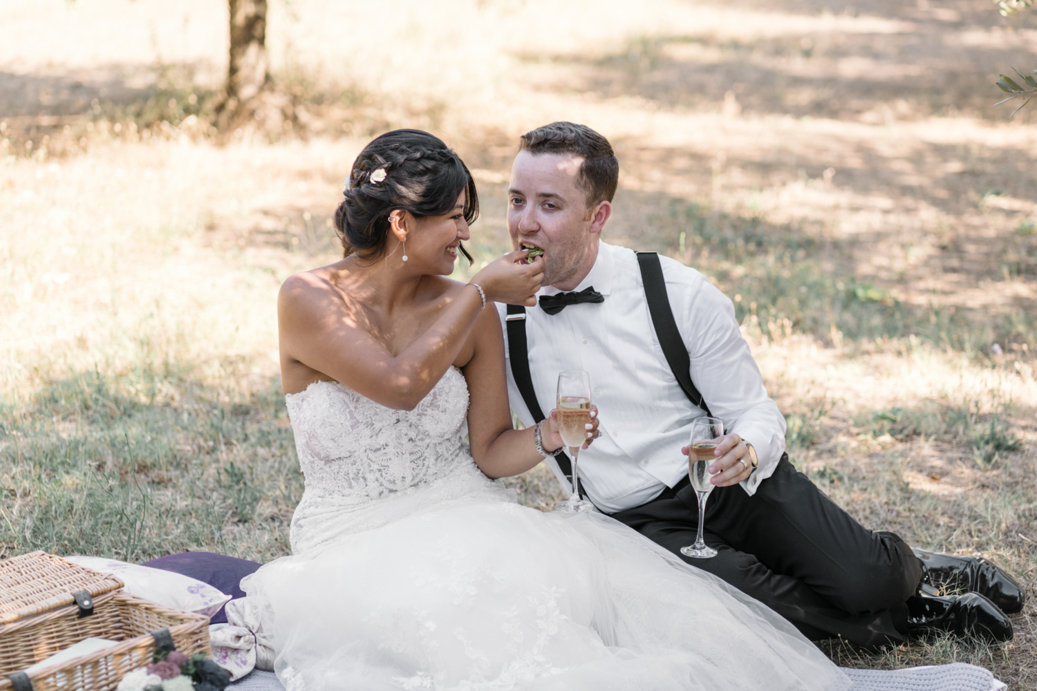 bride feeds macaron to groom in olive grove in gordes