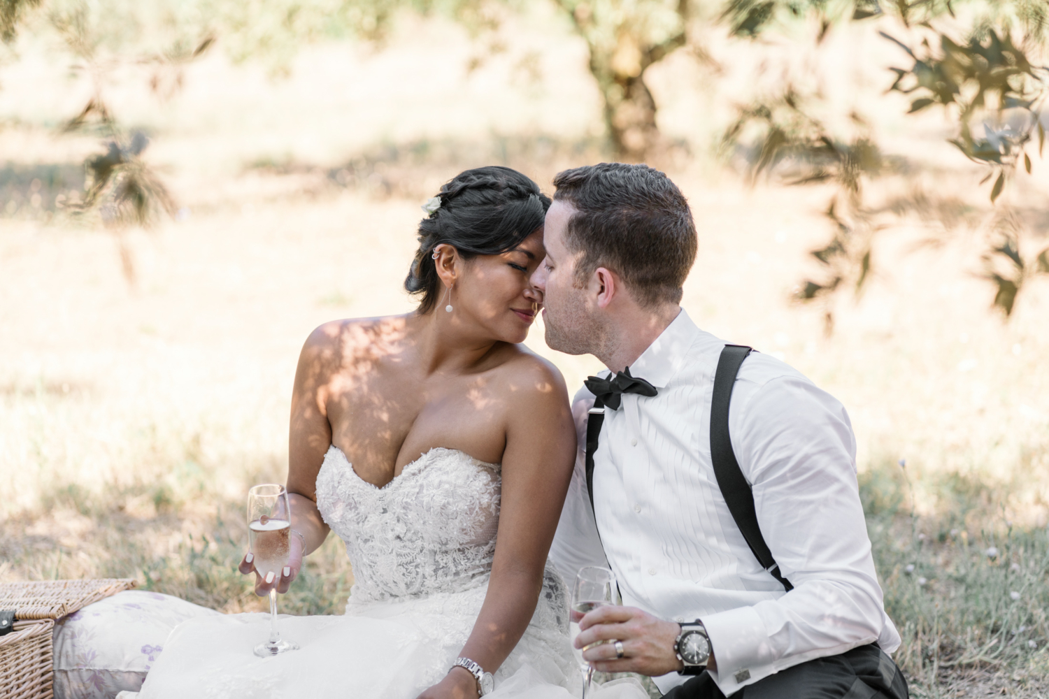 bride and groom hold white wine in olive grove in gordes