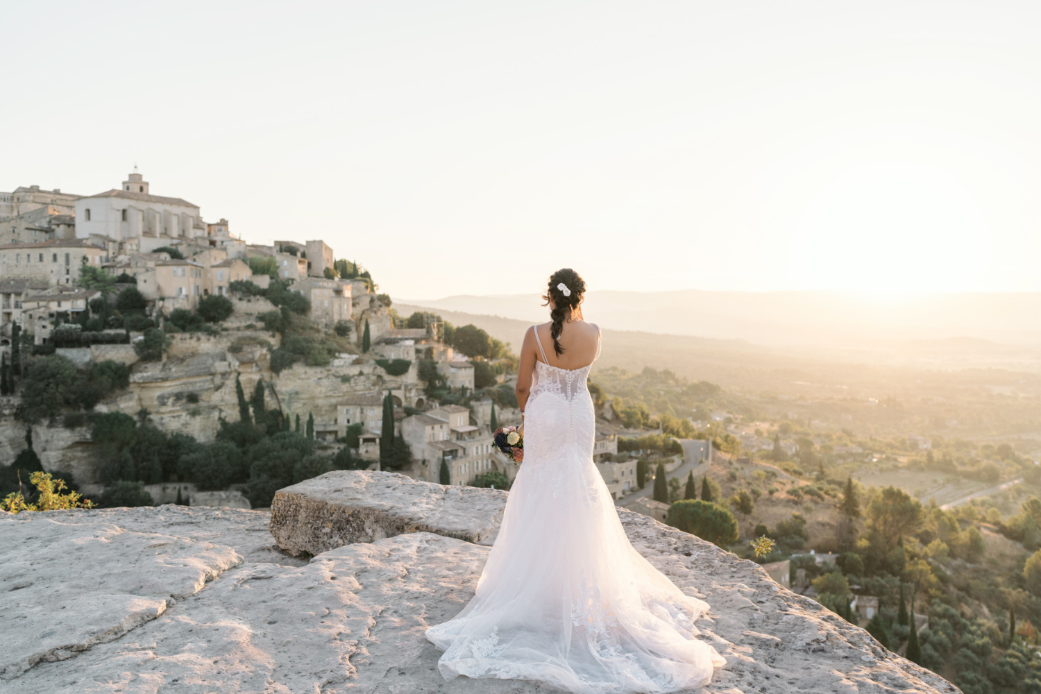 bride poses on wedding day in gordes france