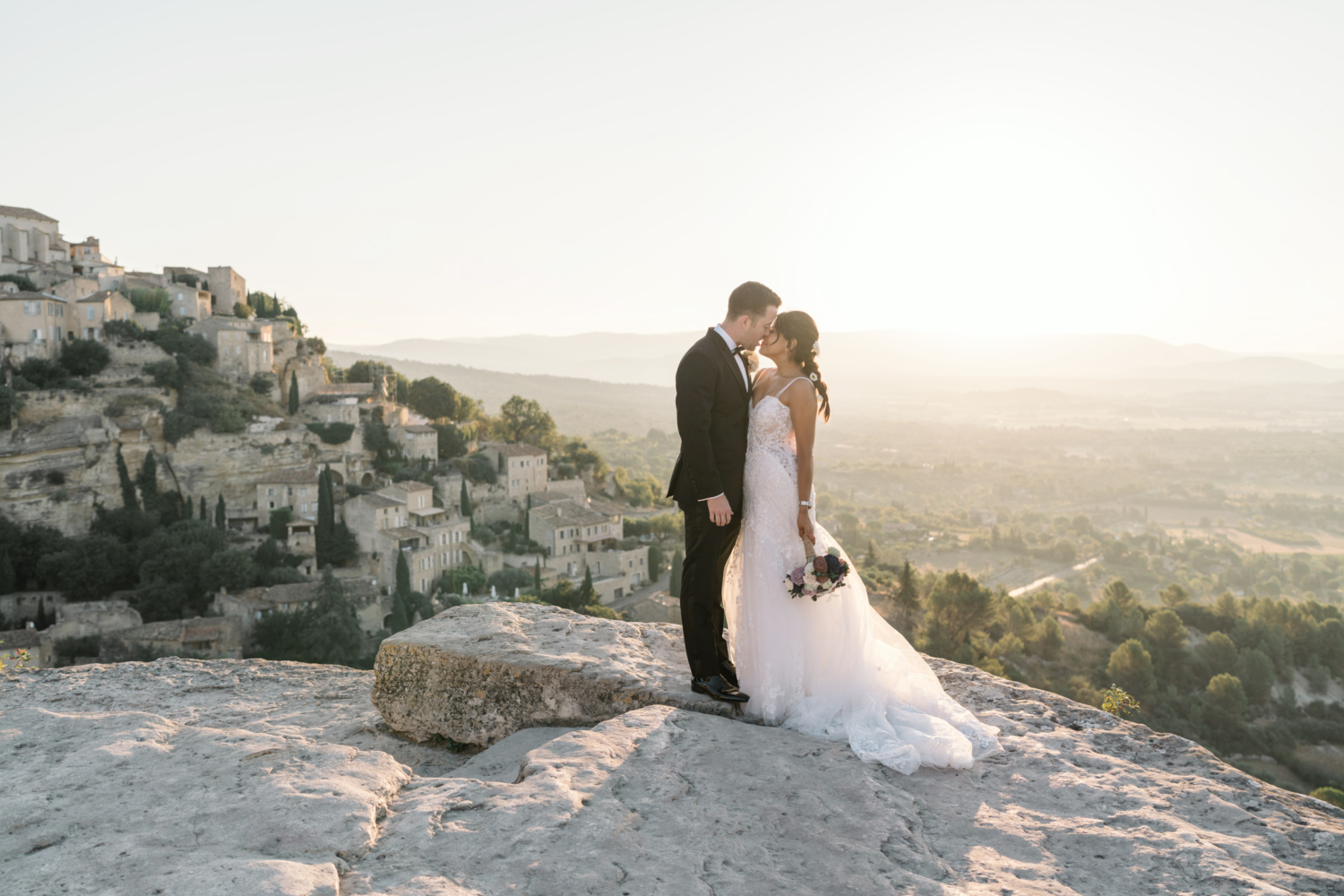 bride and groom have romantic moment at sunrise in gordes france